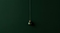 Single dark green ornament hanging from gold chain against deep forest green background, ideal for holiday marketing and seasonal design projects.