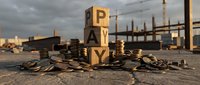 Pay concept with wooden blocks stacked spelling the word surrounded by scattered coins on industrial urban background with factory buildings and cloudy sky.