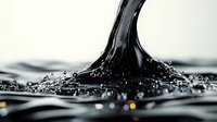 Black liquid drop impact creating crown splash formation with water ripples and droplets against light background, captured in high-speed macro photography.