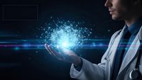 Young male doctor holding glowing digital network in palm showcasing medical technology innovation and healthcare data connectivity solutions.