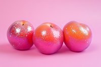 Pink glittery apples with sparkly surface on pink background, modern creative food art concept for festive or holiday decoration and design projects.
