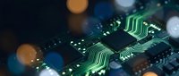 Close-up of circuit board with green glowing pathways and electronic components, representing technology, data processing, and digital innovation for tech industry applications.
