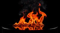 Dramatic orange flames rising from black frying pan against dark background. Hot cooking fire blazing upward with intense heat and energy for culinary concepts.