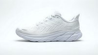 White running shoe with thick cushioned sole isolated on light background, side view, modern athletic footwear for sport and fitness.