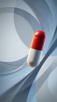 Red and white pharmaceutical capsule pill on abstract geometric background for medical healthcare and medicine industry concepts.