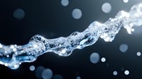 Dynamic water splash with flowing liquid motion and sparkling droplets against dark background for refreshing beverage and hydration concepts.