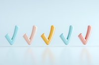 Colorful checkmark symbols in pastel blue, pink and yellow arranged in row on light background with reflection, minimal style composition for business concepts.