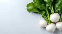 Fresh white round turnips with bright green leaves on light background, raw organic vegetables for healthy eating and cooking. Food photography.