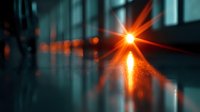 Glowing orange light creates dramatic starburst effect against dark background with reflective surface, adding depth and atmosphere for creative design projects.