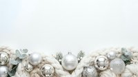 Festive holiday ornaments in silver, white, and champagne tones arranged in a decorative garland with greenery for seasonal celebrations and winter décor projects.