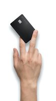 Male hand holding black credit card on white background, isolated for financial services and payment solutions.