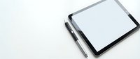 Digital tablet with stylus pen on white background for creative design work and digital art projects.