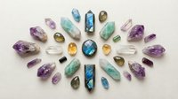 Collection of colorful gemstones and crystals arranged in circular pattern on white background. Amethyst, aquamarine, fluorite minerals isolated.