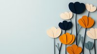 Paper craft flowers in navy blue, orange and cream colors on light blue background create modern minimalist floral composition with elegant shadows.