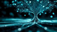 Glowing cyan tree silhouette with light particles and bokeh effect against dark background creates magical atmosphere. Abstract nature concept for spiritual designs.