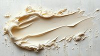 Creamy beige foundation makeup smear with smooth texture on white wooden background, cosmetic product sample for beauty and skincare applications.