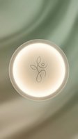 Glowing circular neon light with wellness symbol on soft sage green background, suitable for spa, wellness, and health-related design projects.