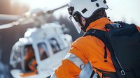 Rescue worker in bright orange safety uniform with helmet and backpack approaching helicopter for emergency mission.