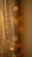 Golden champagne bubbles with warm bokeh lights creating elegant celebration atmosphere for luxury events and festive occasions.