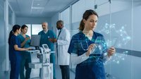 Female Caucasian nurse in scrubs uses futuristic digital tablet with glowing AI network overlay in modern hospital corridor with medical team.