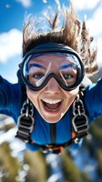 Excited young Caucasian woman skydiver in goggles and gear smiling during freefall with blue sky and clouds background for extreme sports content.