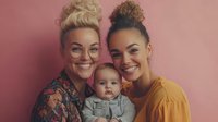 Two young women with baby on pink background representing modern family portrait for lifestyle and parenting content.