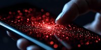 Finger touching smartphone screen with glowing red bokeh light particles emerging, creating magical digital transformation effect on dark background.