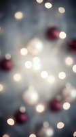 Blurred Christmas lights and red ornaments create dreamy bokeh effect for holiday backgrounds and festive seasonal designs.
