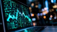 Financial market data displayed on laptop screen with glowing turquoise trading chart against blurred city lights background showing stock price movements.