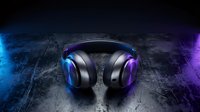 Professional gaming headphones with glowing blue and purple LED lights on ear cups, displayed on textured dark surface with neon lighting effects for gaming, music production, and audio equipment marketing.