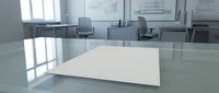 Empty white desk surface in modern office conference room with glass partitions and workstations in background, suitable for product mockups and business presentations.