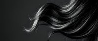 Flowing dark hair in motion against black background showcasing natural movement and texture for beauty and haircare concepts.