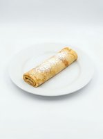 Rolled sponge cake dusted with powdered sugar on white plate against neutral background, suitable for bakery, dessert, and food service marketing materials.