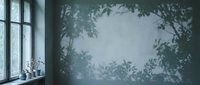 Moody interior with large window casting leafy shadows on textured wall, creating atmospheric botanical ambiance for design, backgrounds, and editorial projects.