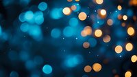 Magical bokeh lights in turquoise blue and warm golden colors create dreamy abstract background with blurred glowing circles and sparkles. Festive mood setting.