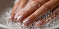 Hands washing with soap and water creating rich lather for hygiene and cleanliness routine in bathroom sink for health and wellness care.