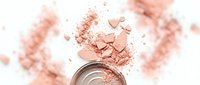 Rose gold eyeshadow powder explosion with compact mirror on white background. Cosmetic makeup product scattered with shimmer particles.