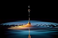 Water drop collision creating concentric ripples with golden splash on dark background, suitable for science, physics education, and abstract design projects.