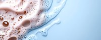 Luxurious foam texture with pink and blue gradient colors merging in abstract pattern, macro photography of soap or cosmetic product background with bubbles.