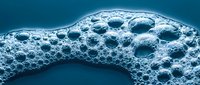 Microscopic view of porous material surface with circular holes and cavities in blue monochrome showing detailed texture and structure for scientific research.