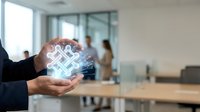 Digital network symbol glowing in businessman's hand with blurred office team in background, representing connectivity, technology integration, and corporate collaboration solutions.