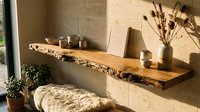 Rustic live edge wooden floating shelf with dried flowers, ceramic bowls, and natural decor against a warm stone wall in a cozy interior.