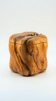 Handcrafted wooden storage box with natural grain patterns and decorative lid knob isolated on white background for artisan home decor and organization.