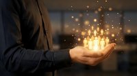 Businessman holding glowing light bulbs in palm, representing innovation, ideas, and creative business solutions for entrepreneurship and success.