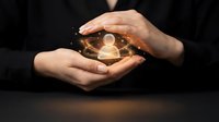 Protective hands cupping glowing human figure with golden light circles, symbolizing care, support, insurance, healthcare and personal protection concepts.