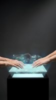 Two hands, one older male and one younger female, interact with a glowing holographic display projecting digital data and technology interface elements against dark background for innovation concepts.