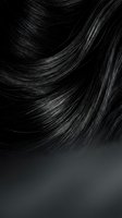 Glossy black hair close-up with smooth flowing strands and silky shine, showcasing healthy texture for beauty and haircare concepts.