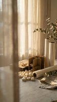 Warm sunlit kitchen counter with wooden boxes, ceramic vases, eucalyptus branches and scattered nuts creating cozy cooking atmosphere for culinary content.