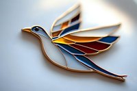 Decorative stained glass bird brooch with gold trim featuring white, blue, and amber wings in flight against soft blurred background. Elegant jewelry design.
