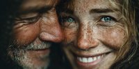 Elderly Caucasian couple sharing intimate moment with genuine smiles and bright eyes showing love, happiness and connection in close-up portrait.